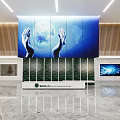 Modern Front Desk Reception Area With Earth Graphic Hands Large Screen And Green Plant Wall