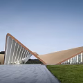Modern Geometric Architecture With Triangular Metal Roof Glass Curtain Wall Open Plaza And Grassland
