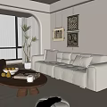 Modern Living Room Interior Design With Beige Sofa Round Coffee Table And Framed Wall Art