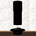 Black Cylindrical Fireplace with Round Base on Wooden Floor against Patterned Wall Modern Design