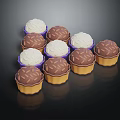 Delicious Assorted Mini Cupcakes With White Cream And Chocolate Crumble Toppings