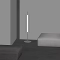 Modern Floor Lamp With Transparent Cylinder Shade Illuminating Minimalist Living Space