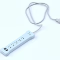 White Electrical Power Strip With Multiple Outlets And Attached Power Cord Plug 3d model