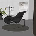 Modern Black Leather Lounge Chair With Metal Frame Artwork And Green Plant In Stylish Interior