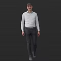 Man in White Shirt and Dark Pants Standing Against Dark Background