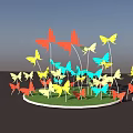 Colorful Butterfly Shaped Landscape Sculpture Illuminated At Night With Surrounding Trees And Reflections In Puddles