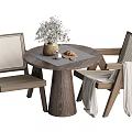 Round Wooden Table and Woven Chair Set with Floral Vase Bread and Light Blanket