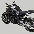 Black Sporty Motorcycle With Golden Accents Against Mountain Forest And Blue Sky