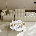 Modern Beige Sectional Sofa With Green Cushion And Round Marble Coffee Table On Light Rug