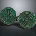 Ancient Bronze Circular Sculptures With Intricate Spiral Patterns And Linked Design
