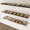 Assorted Meal Containers With Various Foods Displayed On White Shelves