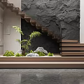 Modern Interior Staircase With Wooden Steps Black Textured Wall Plants And Decorative Rocks