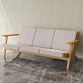 Modern Three Seat Sofa With Wooden Armrests Light Gray Cushions And Marble Floor