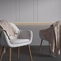 Modern White Armchair With Wooden Legs And Brown Knitted Blanket Against Gray Wall Background