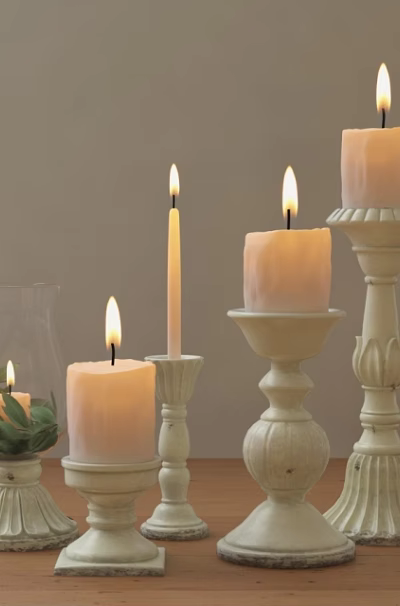 Lit White Candle Lamps with Various Designs on Wooden Tabletop and Glass Vase with Greenery 3d model
