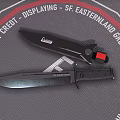 Two Tactical Knives Displayed On Textured Mat