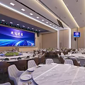 Modern Banquet Hall Setup With Round Tables Comfortable Chairs Marble Tabletops And Large Screen