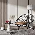 Modern Black Woven Leisure Chair With Brown Cushion Side Table Vase And White Floor Lamp