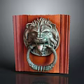 Carved Metal Lion Head Door Knocker On Reddish Brown Wooden Board