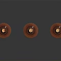 Three Ornate Candle Holders With Lit Candles Red Bases And Carved Details On Dark Surface