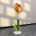 Elegant Floral Display with Orange Yellow Flower Green Leaves and White Pebble Base