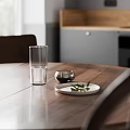Modern Restaurant Interior With Grey Cabinets Wooden Countertop Round Table Four Chairs Window Pendant Light