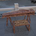 Traditional Wooden Chinese Zither on Stand with Stool in Outdoor Stone Railing Water Setting