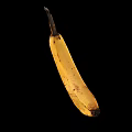 Ripe Banana With Brown Spots On Black Background Curved Shape