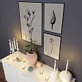 Modern Entryway Cabinet Sideboard With Decorations Candles Vase Green Plant And Wall Paintings