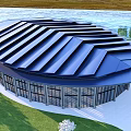Modern Circular Glass Building Exterior With Scenic Waterfront And Green Grass