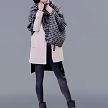 A Woman Wearing Light Pink Long Coat With Checkered Scarf And Black Tight Pants