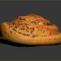 Golden Brown Swirl Baked Pastry Topped With Poppy Seeds On Dark Surface
