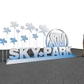 3D Lettering Sign SKY PARK With Butterfly Decorations Person Standing On Hexagonal Tiled Ground