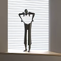 Black Human Shaped Sculpture Standing On Window Sill With Blinds Background And Light Stripes