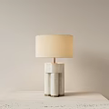 Sleek Modern Table Lamp With Beige Fabric Shade And Geometric Marble Base On Tabletop