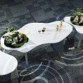 Modern Tea Break Area Featuring Curved White Tables Green Plants And Snacks