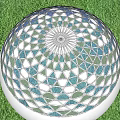 Decorative White Sphere With Blue And Gray Triangular Patterns On Green Grass
