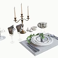 Elegant Dinnerware Set With Candelabra Wine Glasses Folded Napkins And Green Leaf Decor