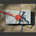 Red Industrial Valve Device On Gray Concrete Base With Red Pipes And Fittings