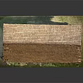 Wooden House With Brown Tile Roof Yellow Walls Stone Foundation And Green Grass