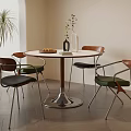 Modern Round Dining Table And Chairs With White Top Metal Base Wooden Accents And Plants