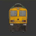 Green Railfreight Freight Train Model With Yellow Front On Dark Reflective Background