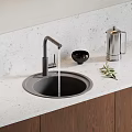 Black Kitchen Sink with Modern Faucet on Light Countertop and Bowl Olive Branch Kettle