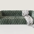 Green Velvet Two Seater Sofa With Tufted Design And Striped Blanket
