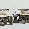 Rattan Table Chair Set with Beige Cushions Small Round Table and Vase with Dried Flowers
