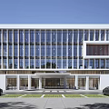 Modern Office Building Exterior With Glass Facade White Structure Front Entrance And Parked Cars