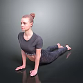Woman Practicing Yoga Pose In Gray Athletic Outfit On Smooth Dark Floor