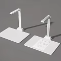 Two White Desktop Scanners With Flexible Arms And Paper On Base