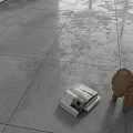 Modern Textured Gray Floor Tiles in Interior Space with Open Magazine and Small Lion Decor
