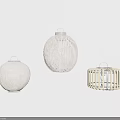 Woven Pendant Lights In Natural Tones With Various Designs Hanging On White Minimalist Wall